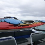 Kayak transporting on the back of the water taxi.
