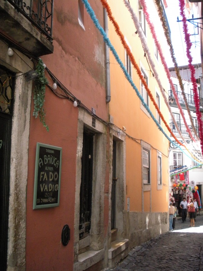 One Day in Lisbon: A colorful alleyway with streamers in Alfama.