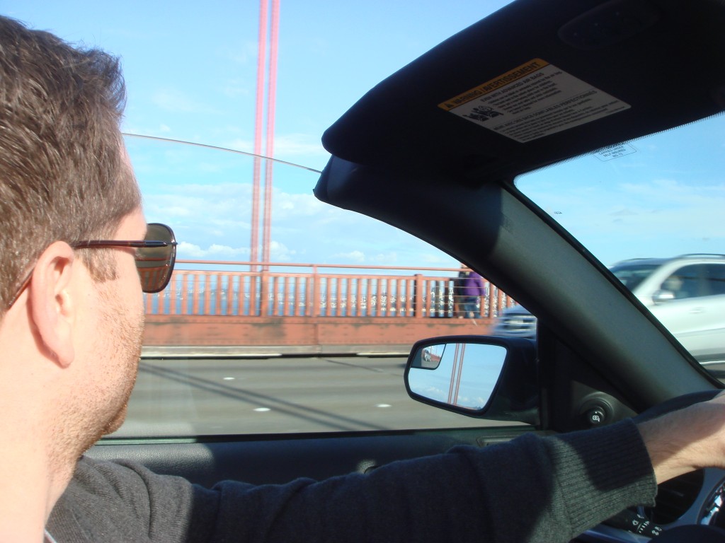 Driving along the Golden Gate Bridge in a Convertible