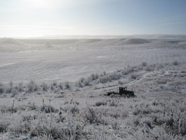 A tractor in the snow at my grandparent's farm.