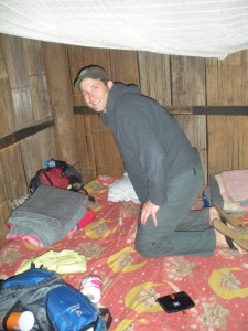 Tom getting our sleep spot ready in the bamboo hut.