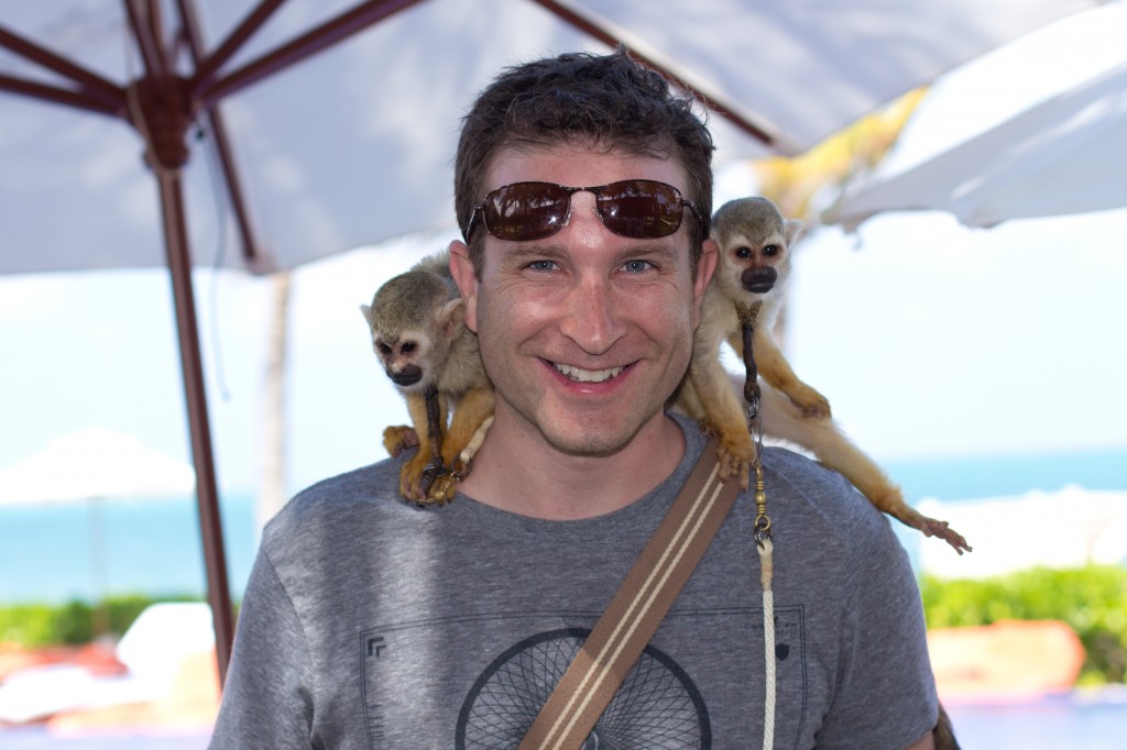 Tom playing with monkeys at Zoetry Resort.