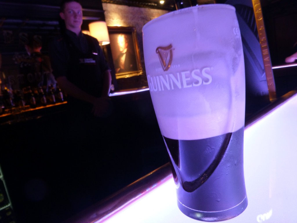 Drinking a Guinness at the Connoisseur Bar in Dublin. I was about to learn a lot about this hearty stout, including how to pour a Guinness and the right way to drink a Guinness. 