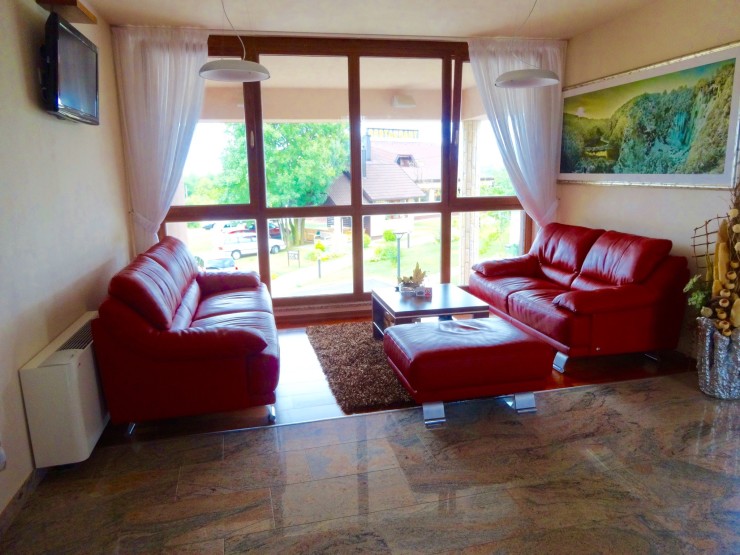 Hotel Degenija sitting area with a view of Degenija Restaurant through the window. 