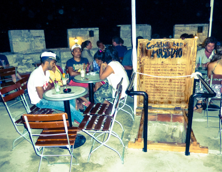 Sipping drinks on top of the tower by the ladder entrance. 