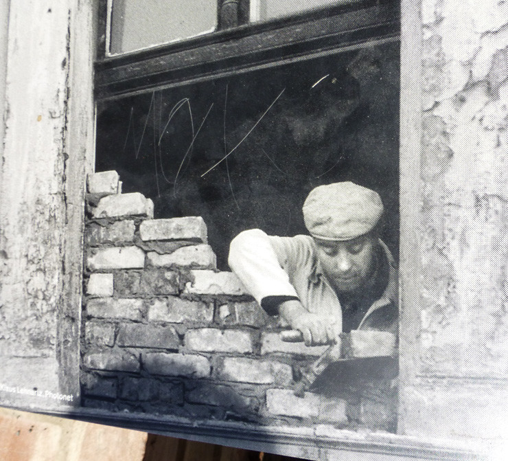 An image shown at the Berlin Wall Memorial of windows being bricked up. 