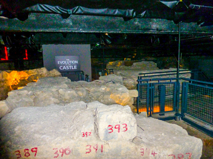 Old unearthed stones in St. John's Castle with informational boards in Limerick. 