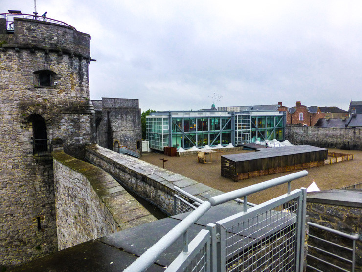 View of Limerick's St. John's Castle's courtyard with new addition, complete with a cafe, behind it. 