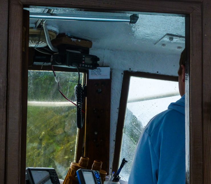 Captain skillfully navigating the boat to Skellig Michael's little pier. 