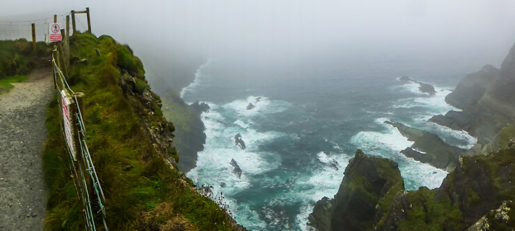 Rugged and rough waves on a cloudy day at Kerry's Most Spectacular Cliffs along the Ring of Kerry. 