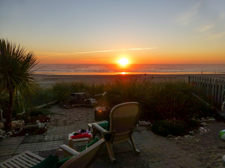 Rockaway Beach at sunset seen from a vacation rental patio. 