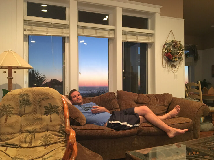 Lounging in comfort in our vacation rental -- look at those ocean and sunset views through the window!