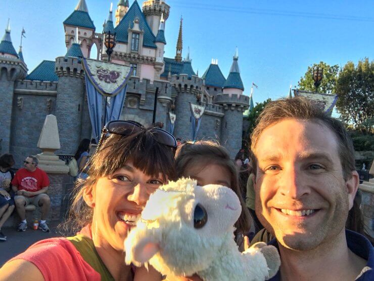 Family selfie time in front of Sleeping Beauty Castle at Disneyland