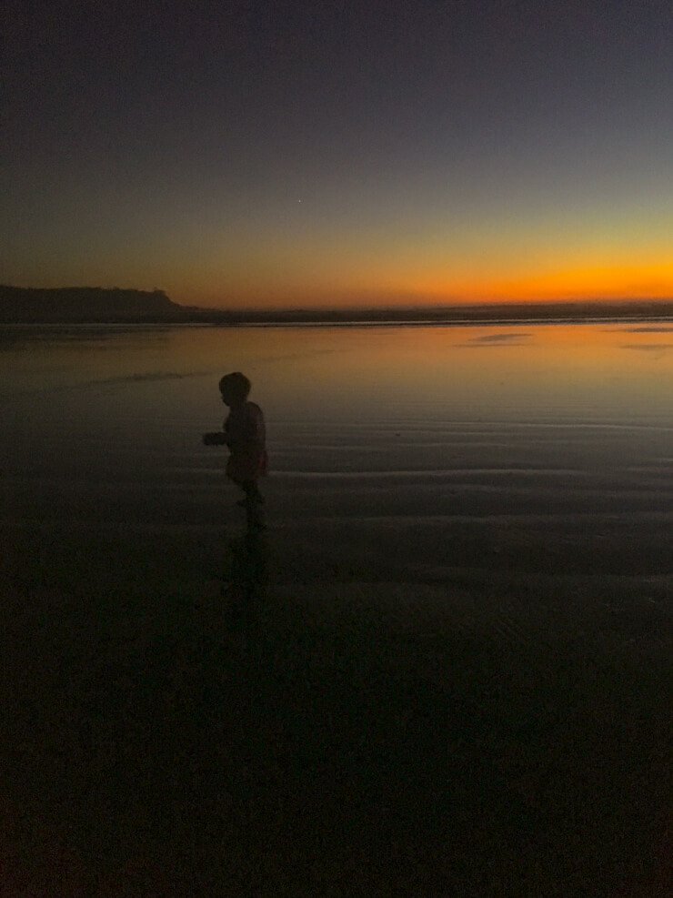 Toddler and a Tofino sunset on Vancouver Island, British Columbia