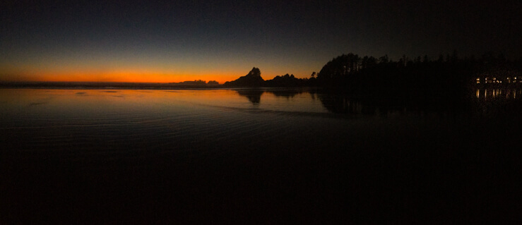 Panoramic shot of a sunset in Tofino on Cox Beach Bay