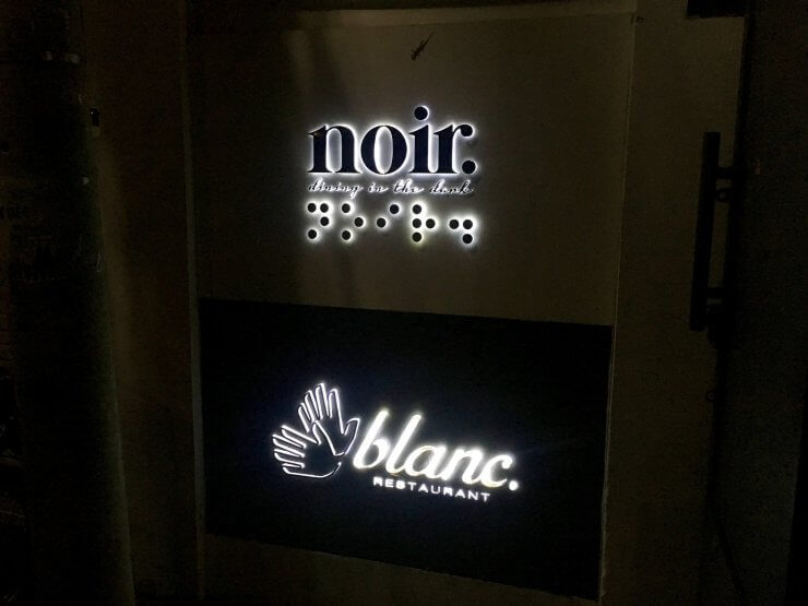 Welcome signs for Noir and Blanc Restaurants in Ho Chi Minh City, unique dining experiences that include eating in the dark or ordering using sign language. 