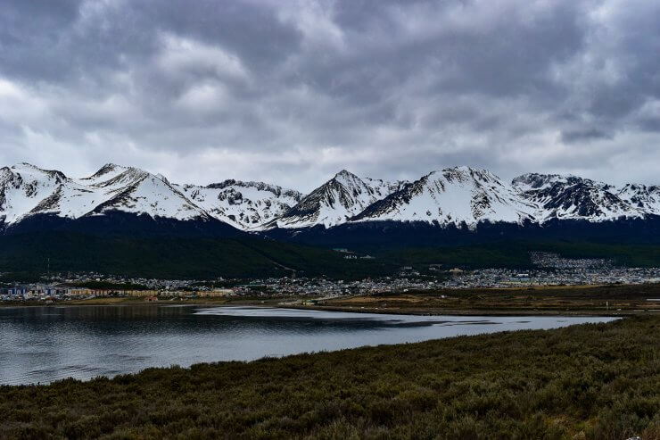 Ushuaia, Argentina seen from afar and framed by snowcapped mountains. 