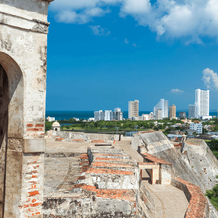 Castillo San Felipe with view of Cartagena's skyscrapers. The Castillo San Felipe is a must-visit even if you have just one day in Cartagena. 