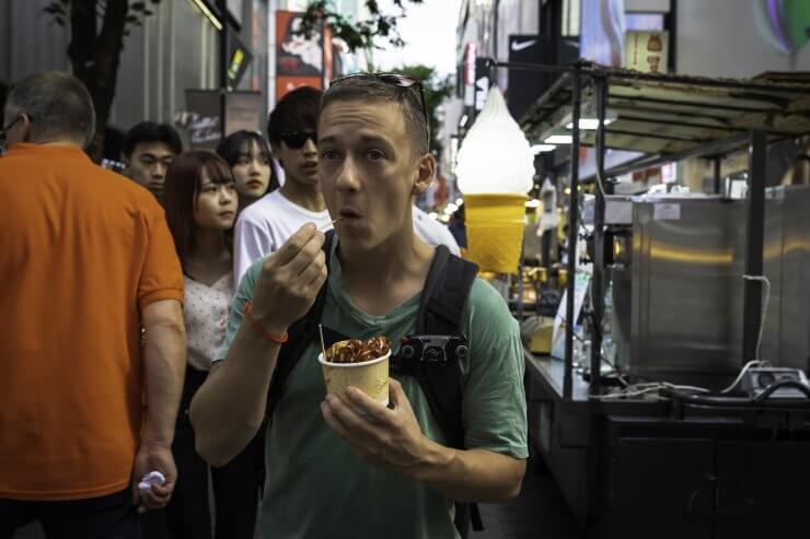 Enjoying a bite to eat in Myeongdong, a great neighborhood to visit during a 1 day in Seoul itinerary. 