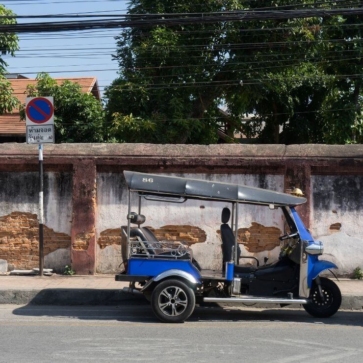 Parked tuk tuk in Chiang Mai, Thailand. A tuk tuk is an affordable way to get around during your day in Chiang Mai. 