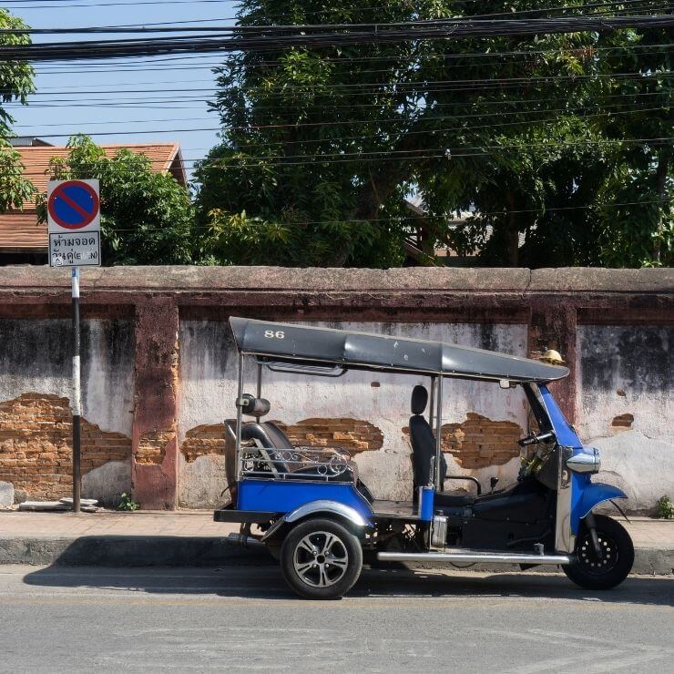 Parked tuk tuk in Chiang Mai, Thailand. A tuk tuk is an affordable way to get around during your day in Chiang Mai. 