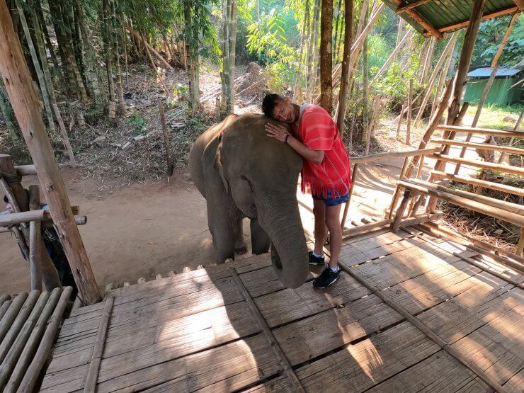 Hugging a young elephant at the Elephant Nature Park in Chiang Mai, Thailand