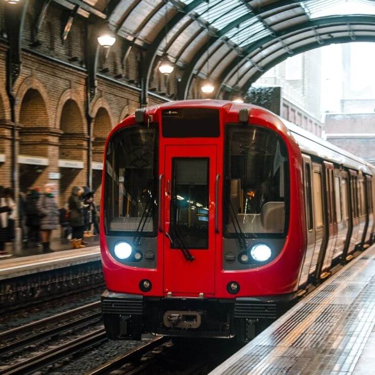 Passengers waiting for the metro in and Underground Station in London. The London subway is an easy and fast way to get around during one day in London.