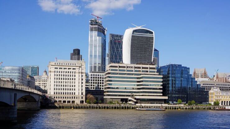 A view of the River Thames and industrial looking buildings in London.