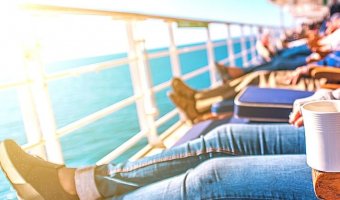 Group of travelers relaxing on a cruise ship terrace.